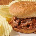 Image of Barbeque sandwich, chips and a drink